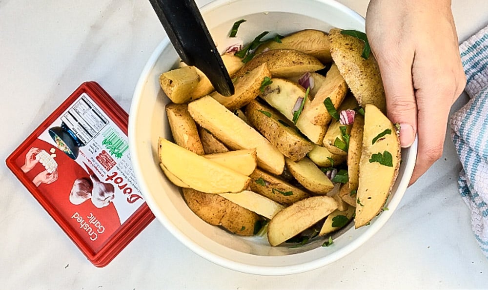 Lifestyle blogger Jenny Meassick of the weekend blog Chocolate and Lace shares her recipe for Garlic Potato Wedges featuring Dorot Fresh Garlic and Herbs.
