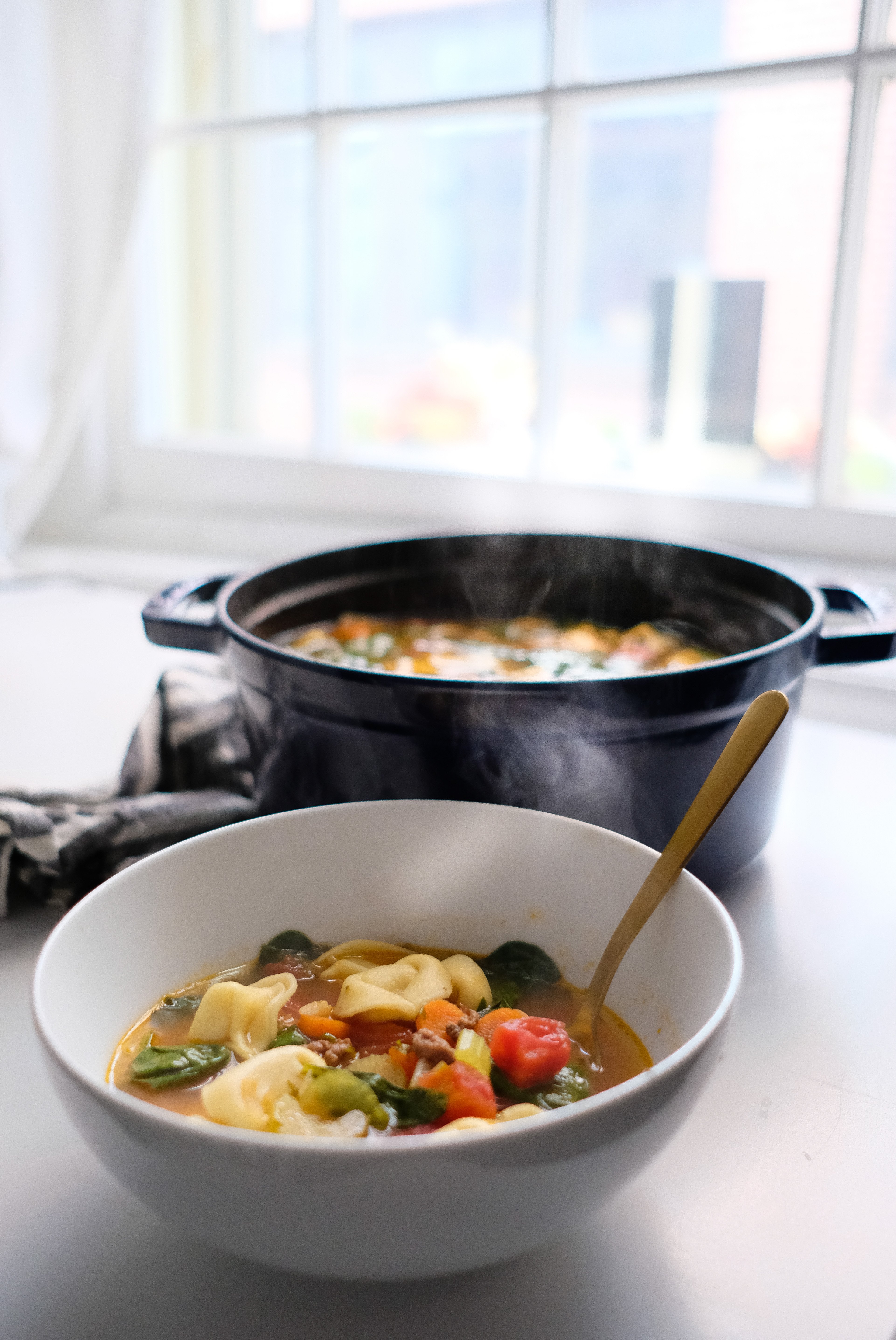 Lifestyle blogger Chocolate & Lace shares a delicious recipe for hearty Tortellini and Arugula Soup.