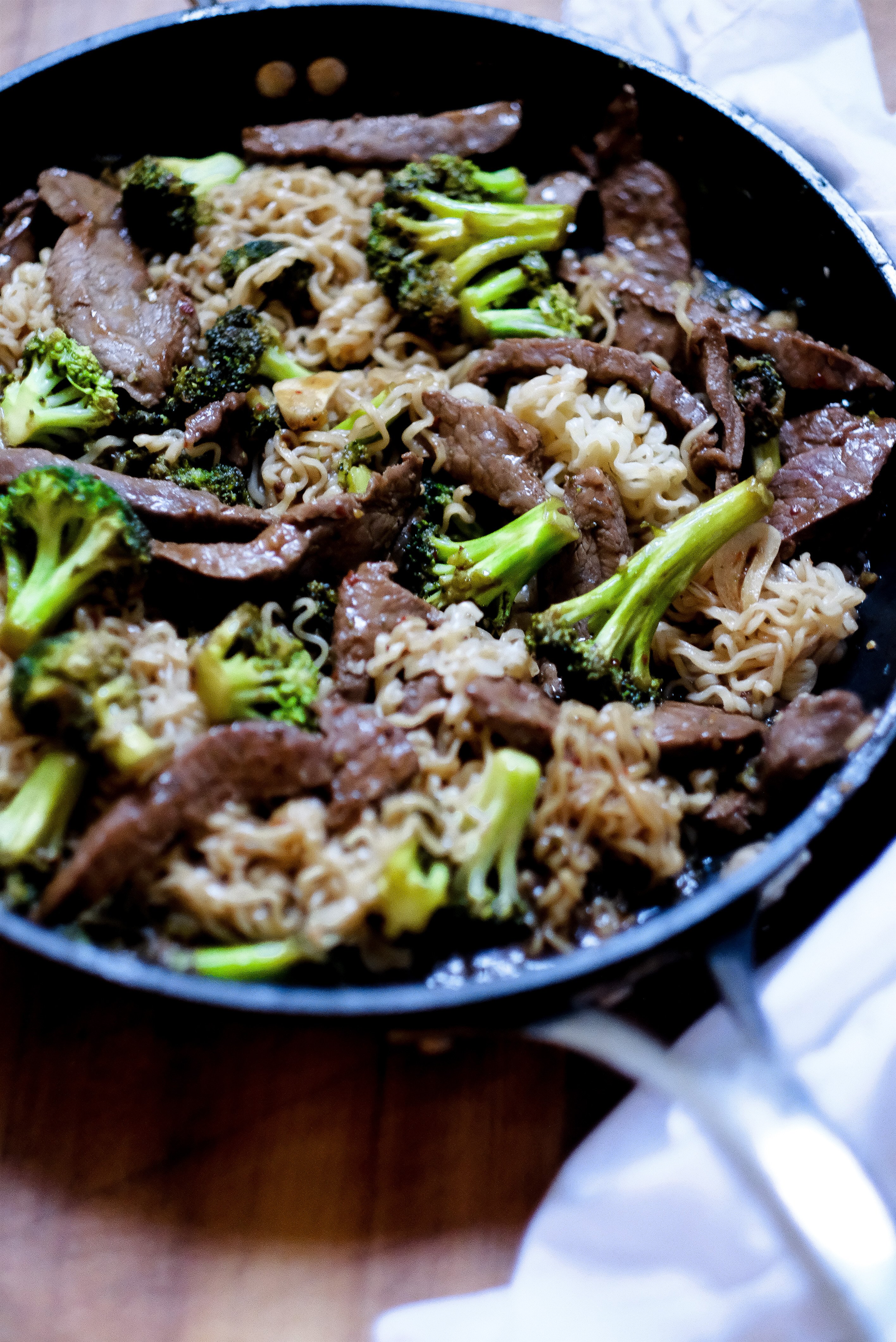 a frying pan containing Teriyaki Beef Ramen Bowl Recipe and green broccoli