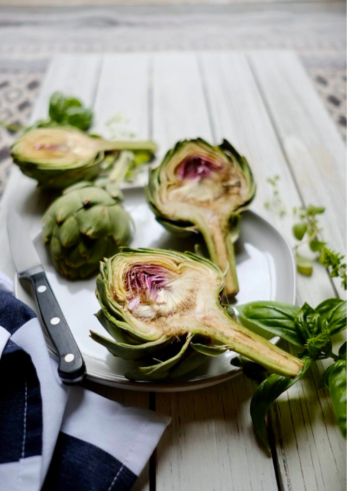 how to steam artichokes an artichoke cut in half on a plate. 