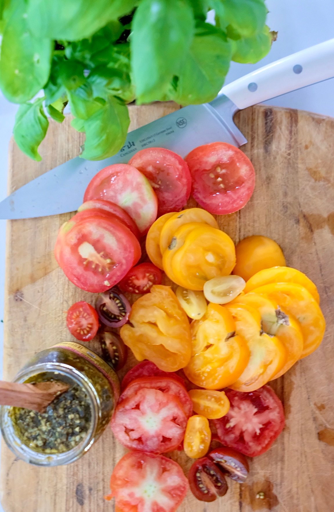 Sliced yellow and red tomatoes for Tomato Tart. 